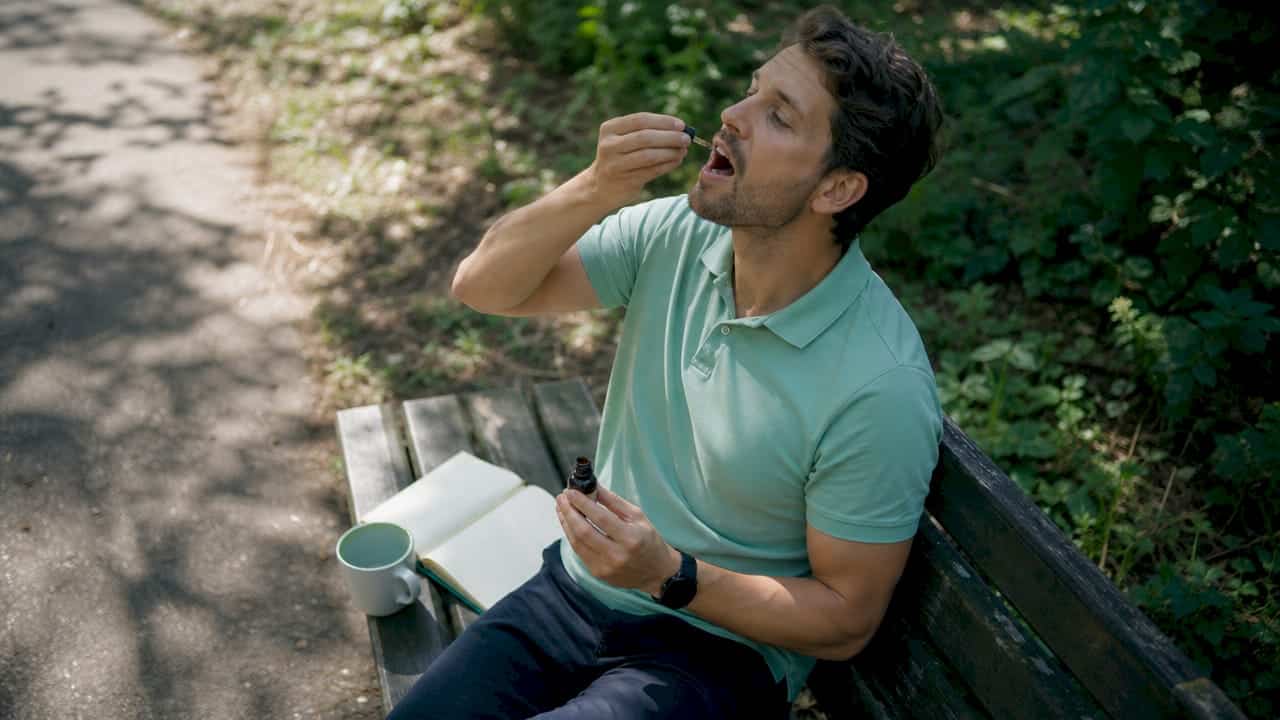A person who uses CBD oil to better manage their stress.