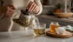 Gently pour hot water into a glass cup containing a CBD infusion.