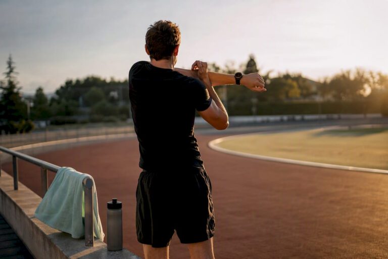 An athlete stretching at the end of his workout