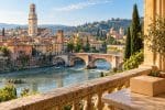 Illustration d’un colis sans marquage sur une terrasse, avec une vue évoquant l’Adige et le Ponte Pietra à Vérone.
